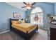 Comfortable guest bedroom with a queen-size bed and a ceiling fan at 141 Hunters Way, Villa Rica, GA 30180