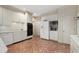 Bright kitchen with white cabinets, a herringbone tile floor, and stainless steel appliances at 28 Ridgemere Trce, Atlanta, GA 30328