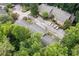 Aerial view of townhouses nestled in a wooded area with ample parking at 2927 Torreya Se Way, Marietta, GA 30067