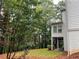 House exterior with deck and wooded backyard at 1800 Riverglen Dr, Suwanee, GA 30024