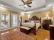 Main bedroom with hardwood floors, access to patio, and ensuite bath at 200 Suffolk Way, Mcdonough, GA 30252