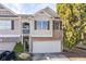 Two-story townhome with stone and siding exterior, attached garage, and balcony at 3112 Spicy Cedar Ln, Lithonia, GA 30038