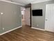 Spacious bedroom with wood-look floors and access to hallway at 723 Casplan Sw St, Atlanta, GA 30310