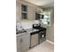 Modern kitchen with gray cabinets, stainless steel appliances, and granite countertops at 723 Casplan Sw St, Atlanta, GA 30310