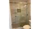 Large walk-in shower with marble-look tile and glass door at 723 Casplan Sw St, Atlanta, GA 30310