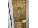 Walk-in shower with marble-look tile and glass door at 723 Casplan Sw St, Atlanta, GA 30310