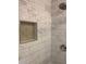 Shower detail with marble-look tile and niche at 723 Casplan Sw St, Atlanta, GA 30310