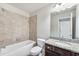 Bathroom with tub, granite vanity and neutral tile at 2182 Nillville Dr, Buford, GA 30519