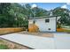 Side yard with a concrete patio and modern wooden stairs at 1048 Pinehurst Se Dr, Smyrna, GA 30080