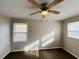 Bright bedroom with ceiling fan and wood-look flooring at 422 Windsor Dr, Forest Park, GA 30297