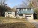 Ranch style home with blue siding, attached garage, and landscaped yard at 422 Windsor Dr, Forest Park, GA 30297
