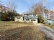 Ranch style home with blue siding, attached garage, and landscaped yard at 422 Windsor Dr, Forest Park, GA 30297