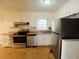 Kitchen with white cabinets, stainless steel appliances, and tile floor at 422 Windsor Dr, Forest Park, GA 30297