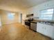 Kitchen with white cabinets, stainless steel appliances, and tile floor at 422 Windsor Dr, Forest Park, GA 30297