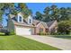 Brick house with a large driveway and a two-car garage at 1395 Fountain Cove Ln, Lawrenceville, GA 30043