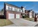 Two-story house with brick and siding, three-car garage, and landscaped yard at 3402 Newtons Crest Cir, Snellville, GA 30078