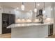 Kitchen island with white cabinets, quartz countertops, and black appliances at 2911 Bentwood Dr, Marietta, GA 30062