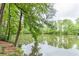 Peaceful lake view with lush green trees and tranquil water at 2911 Bentwood Dr, Marietta, GA 30062