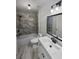 Updated bathroom with marble tile and modern vanity at 3714 Thunder Ne Way, Marietta, GA 30066