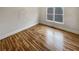 Simple bedroom with hardwood floors and large window at 3714 Thunder Ne Way, Marietta, GA 30066