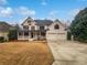 Two story house with a three-car garage and large front yard at 3714 Thunder Ne Way, Marietta, GA 30066