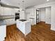 Kitchen with white cabinets, island, and hardwood floors at 3714 Thunder Ne Way, Marietta, GA 30066