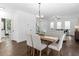 Dining room with a wooden table, white chairs, and a view of the living room at 741 Knox Se Dr, Atlanta, GA 30315