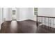 Spacious hallway with dark hardwood floors and an open staircase at 741 Knox Se Dr, Atlanta, GA 30315