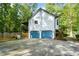 Two-car garage with blue doors and driveway at 3054 Chelsea Ln, Acworth, GA 30102