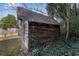 Rustic wooden shed with metal roof and ivy growth at 3953 Rhyne Se Way, Smyrna, GA 30082