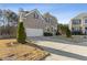 Two-story brick home with stone accents, three-car garage, and manicured lawn at 2007 Hamilton Lake Ct, Buford, GA 30519