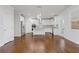 Open concept kitchen with island, white cabinets, and hardwood floors at 2007 Hamilton Lake Ct, Buford, GA 30519