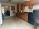 Kitchen with wood cabinets, appliances, and tile floor at 271 Andrew Hairston Nw, Atlanta, GA 30314