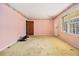 Living room with pink walls and original flooring at 1136 Powell Se Ct, Atlanta, GA 30316