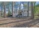 House with attached garage and deck, surrounded by trees at 3952 Fairington Dr, Marietta, GA 30066