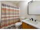 Clean bathroom with updated vanity and striped shower curtain at 5862 Homestead Cir, Rex, GA 30273