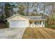 Cute yellow house with a 2-car garage and front porch at 5862 Homestead Cir, Rex, GA 30273