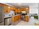 Modern kitchen with stainless steel appliances and wood cabinets at 5862 Homestead Cir, Rex, GA 30273