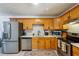 Updated kitchen featuring stainless steel appliances and wood cabinetry at 5862 Homestead Cir, Rex, GA 30273