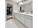 Double vanity bathroom with white cabinets and flooring at 308 Overbend Landing Sw, Marietta, GA 30008