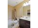Clean bathroom with a shower/tub combo, dark vanity, and a large mirror at 1255 Mcminn Way, Snellville, GA 30078