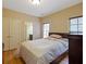 Comfortable bedroom with double doors, attached bath, and hardwood floors at 1255 Mcminn Way, Snellville, GA 30078