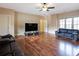 Spacious bonus room with hardwood floors, two leather sofas, and a large TV at 1255 Mcminn Way, Snellville, GA 30078