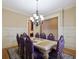 Elegant dining room features a large table with purple chairs and a beautiful chandelier at 1255 Mcminn Way, Snellville, GA 30078