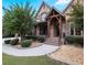 Brick and stone front porch with landscaping and walkway at 1255 Mcminn Way, Snellville, GA 30078