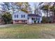 Cute ranch home with light blue siding, brick accents, and a well-manicured lawn at 1095 Rackley Nw Way, Kennesaw, GA 30144