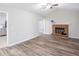 Living room with fireplace, hardwood floors, and kitchen view at 1095 Rackley Nw Way, Kennesaw, GA 30144