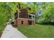 Brick and wood exterior of house with driveway at 1303 N Druid Hills Ne Rd, Brookhaven, GA 30319