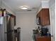 Small galley kitchen with stainless steel appliances at 237 Chads Ford Way, Roswell, GA 30076