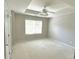 Main bedroom with carpet, ceiling fan, and large window at 230 Valley Xing, Canton, GA 30114